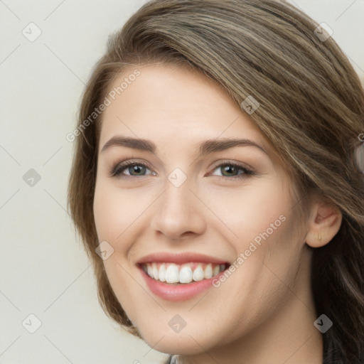 Joyful white young-adult female with long  brown hair and grey eyes