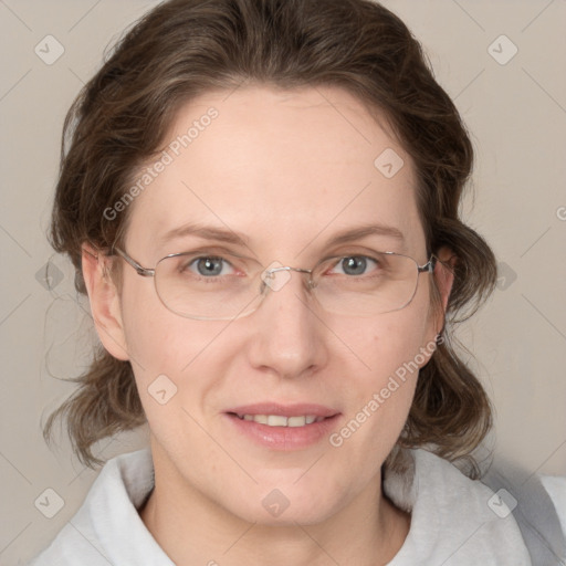 Joyful white adult female with medium  brown hair and blue eyes