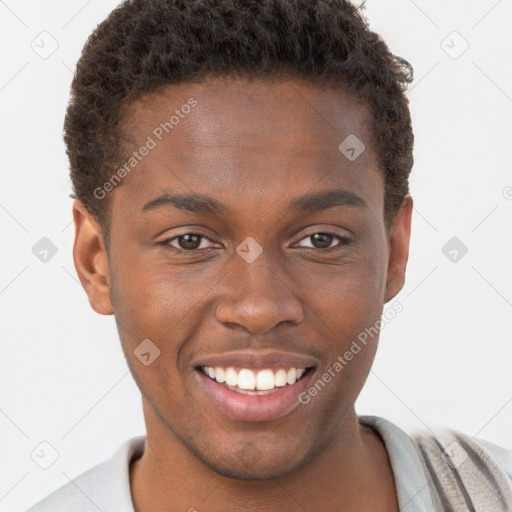 Joyful black young-adult male with short  brown hair and brown eyes