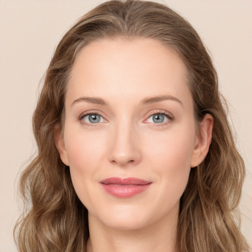 Joyful white young-adult female with long  brown hair and blue eyes