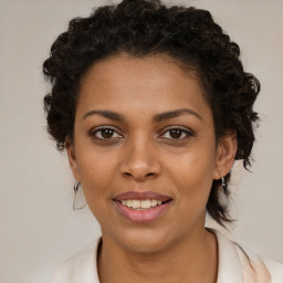 Joyful black young-adult female with medium  brown hair and brown eyes