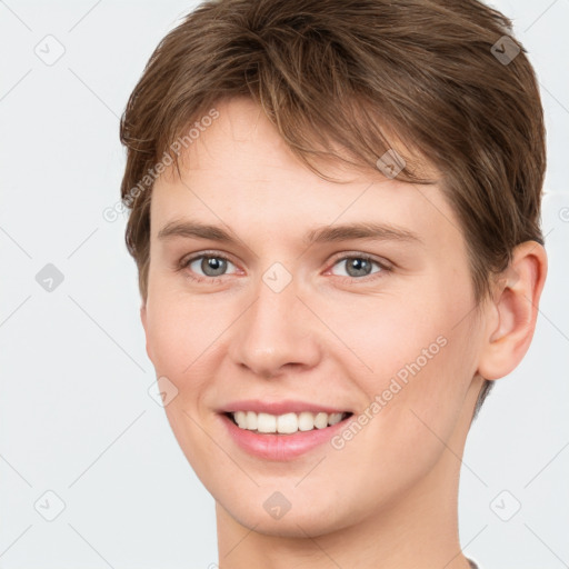 Joyful white young-adult female with short  brown hair and grey eyes