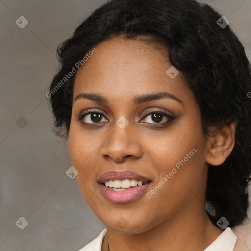 Joyful black young-adult female with long  black hair and brown eyes