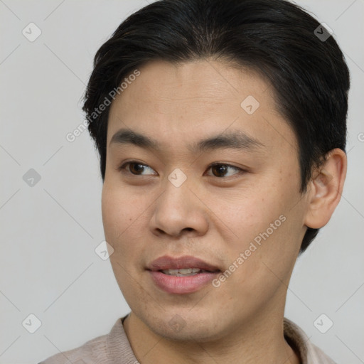 Joyful asian young-adult male with short  brown hair and brown eyes