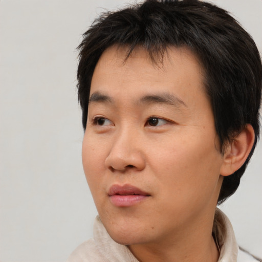 Neutral asian young-adult male with short  brown hair and brown eyes