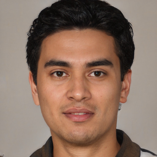 Joyful white young-adult male with short  black hair and brown eyes