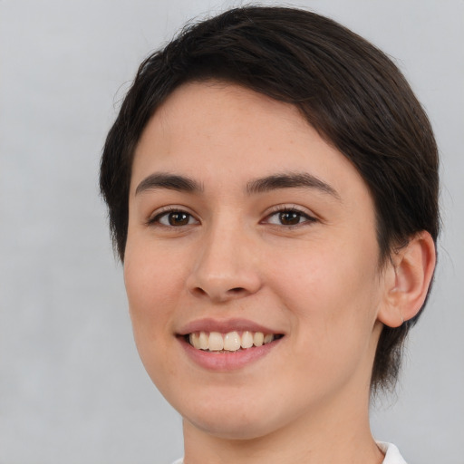 Joyful white young-adult female with medium  brown hair and brown eyes