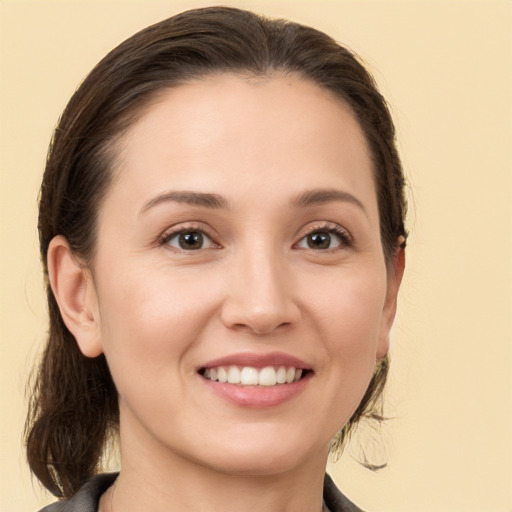 Joyful white young-adult female with medium  brown hair and brown eyes