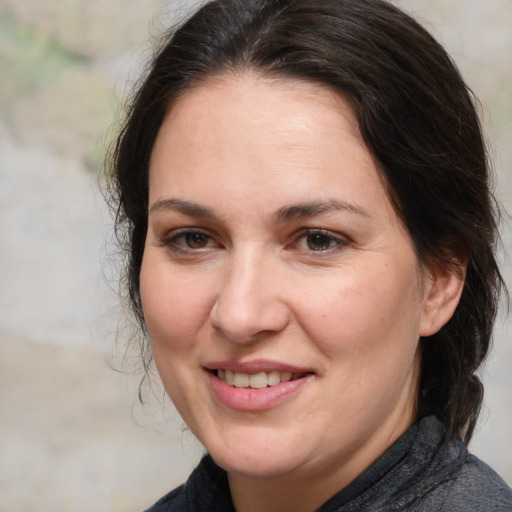 Joyful white adult female with medium  brown hair and brown eyes