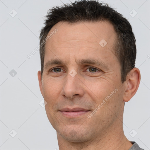 Joyful white adult male with short  brown hair and brown eyes