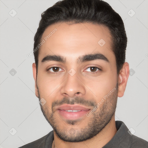 Joyful white young-adult male with short  black hair and brown eyes