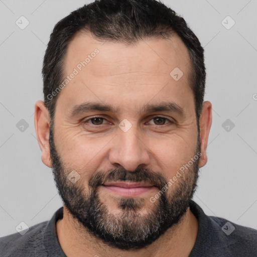 Joyful white adult male with short  black hair and brown eyes