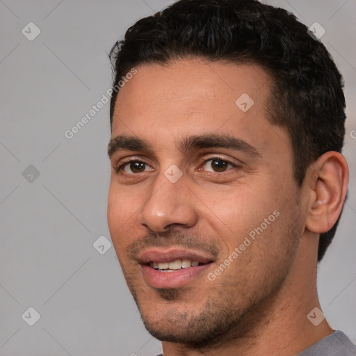 Joyful white young-adult male with short  black hair and brown eyes