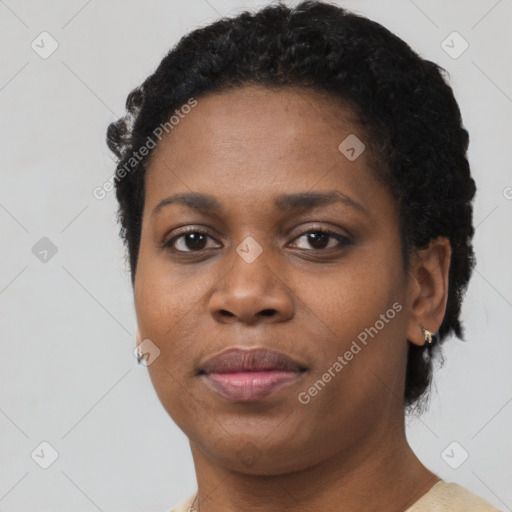 Joyful black young-adult female with short  black hair and brown eyes