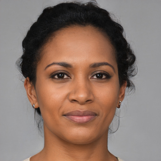Joyful black young-adult female with medium  brown hair and brown eyes