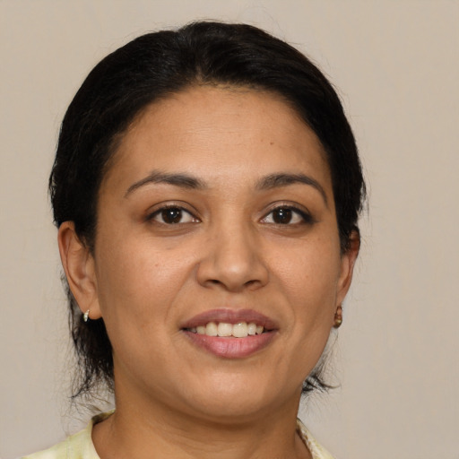 Joyful latino adult female with medium  brown hair and brown eyes