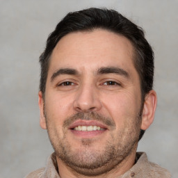 Joyful white adult male with short  brown hair and brown eyes