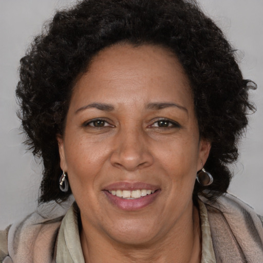Joyful black adult female with short  brown hair and brown eyes