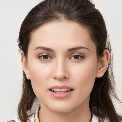 Joyful white young-adult female with long  brown hair and brown eyes