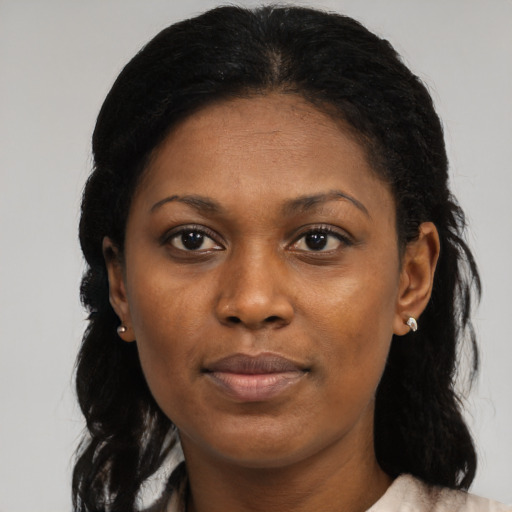 Joyful black adult female with medium  black hair and brown eyes