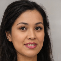 Joyful asian young-adult female with long  brown hair and brown eyes