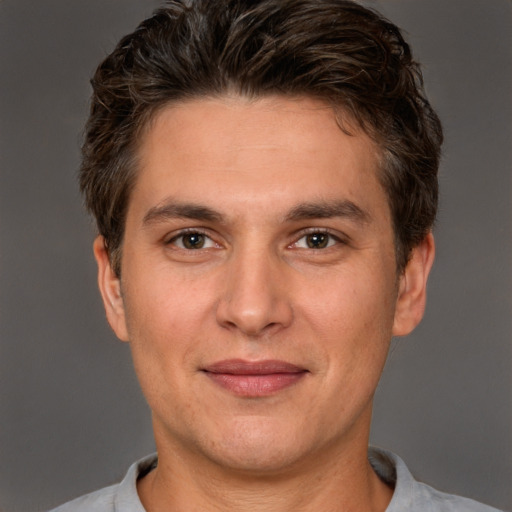 Joyful white adult male with short  brown hair and brown eyes