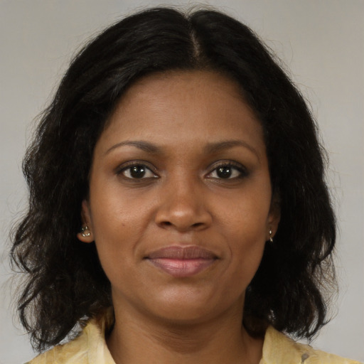 Joyful black young-adult female with medium  brown hair and brown eyes