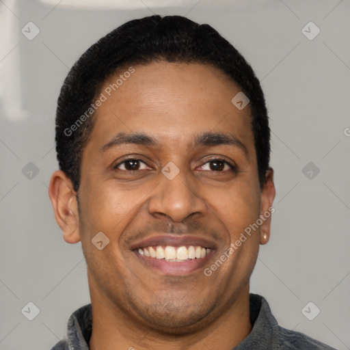 Joyful latino adult male with short  brown hair and brown eyes