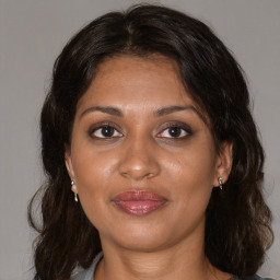 Joyful black adult female with medium  brown hair and brown eyes