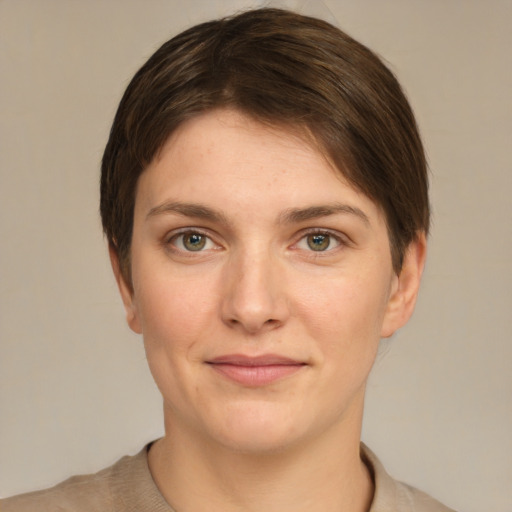 Joyful white young-adult female with short  brown hair and green eyes