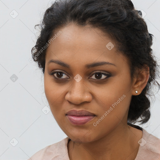 Joyful black young-adult female with long  brown hair and brown eyes