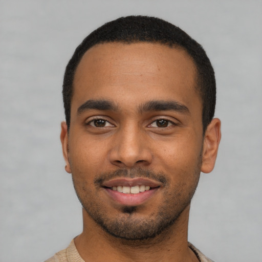 Joyful latino young-adult male with short  black hair and brown eyes