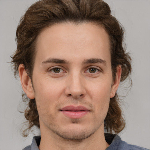 Joyful white adult male with medium  brown hair and brown eyes