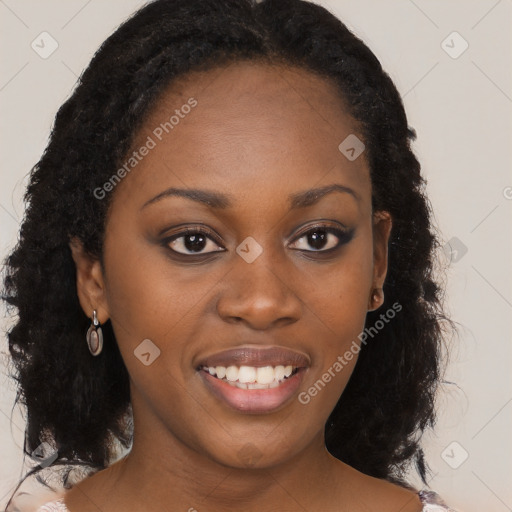 Joyful black young-adult female with long  brown hair and brown eyes