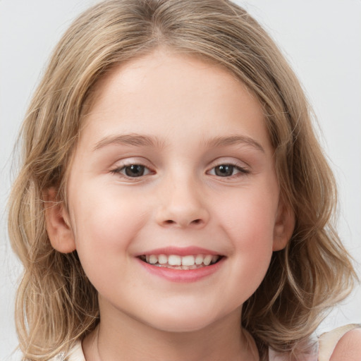 Joyful white child female with medium  brown hair and brown eyes