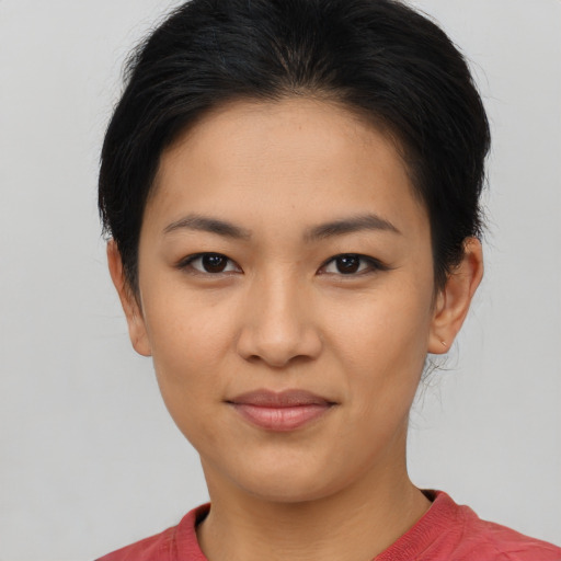 Joyful asian young-adult female with short  brown hair and brown eyes
