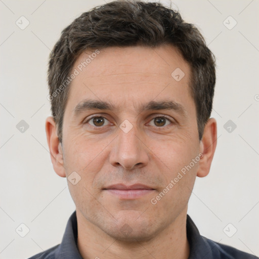 Joyful white adult male with short  brown hair and brown eyes