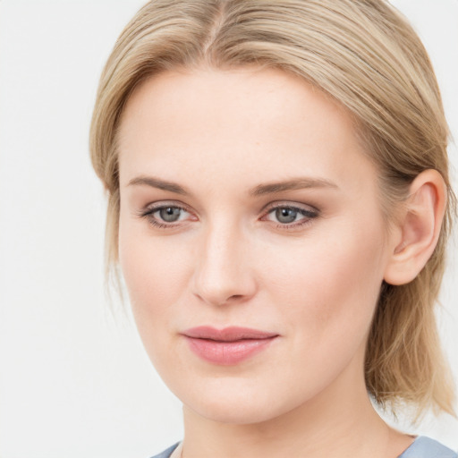 Joyful white young-adult female with medium  brown hair and blue eyes