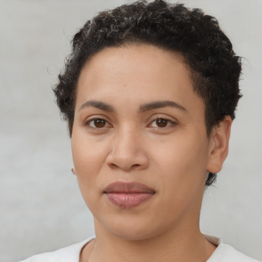 Joyful black young-adult female with short  brown hair and brown eyes