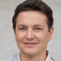 Joyful white adult male with short  brown hair and brown eyes