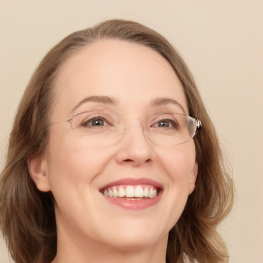 Joyful white adult female with long  brown hair and blue eyes