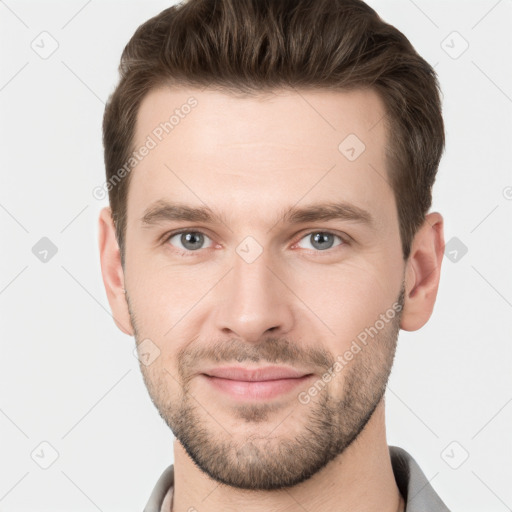 Joyful white young-adult male with short  brown hair and grey eyes