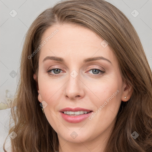 Joyful white young-adult female with long  brown hair and blue eyes