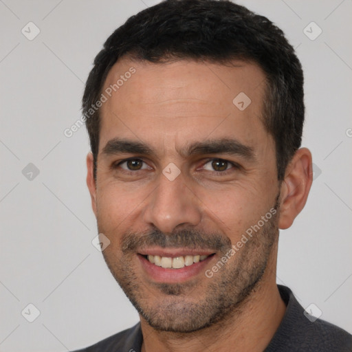 Joyful white adult male with short  black hair and brown eyes