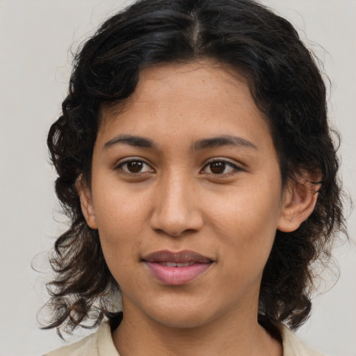 Joyful latino young-adult female with medium  brown hair and brown eyes