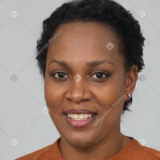 Joyful black adult female with short  brown hair and brown eyes