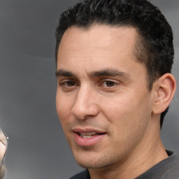 Joyful white adult male with short  black hair and brown eyes