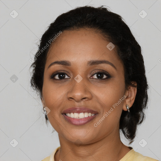 Joyful black young-adult female with long  black hair and brown eyes