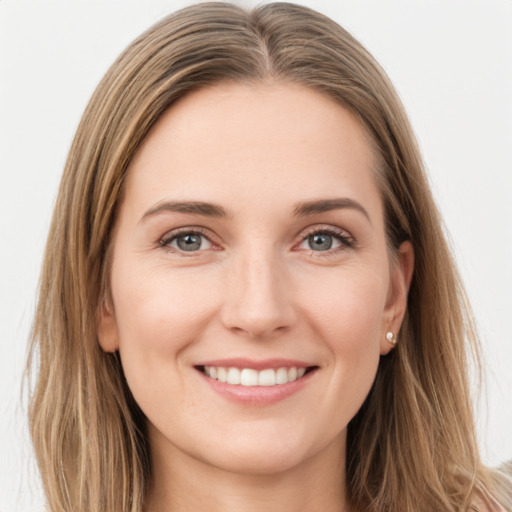 Joyful white young-adult female with long  brown hair and green eyes