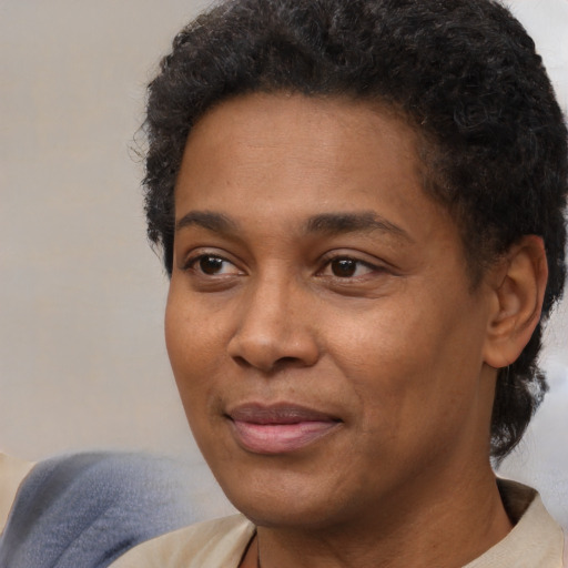 Joyful black adult male with short  brown hair and brown eyes